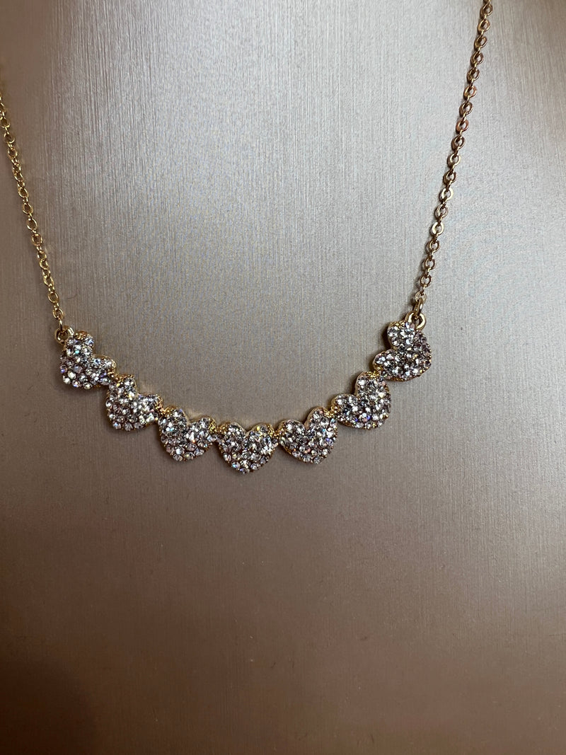 GOLD AND DIAMANTE ROW OF HEARTS NECKLACE